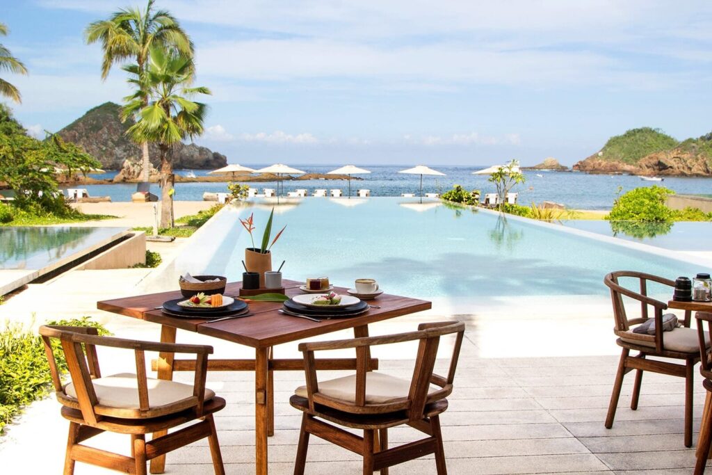 Tables beside the pool at La Duna, Careyes