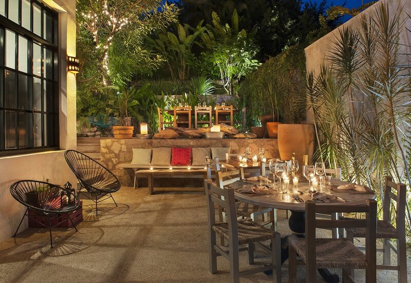 Courtyard tables among plants at Pueblo 25, Careyes