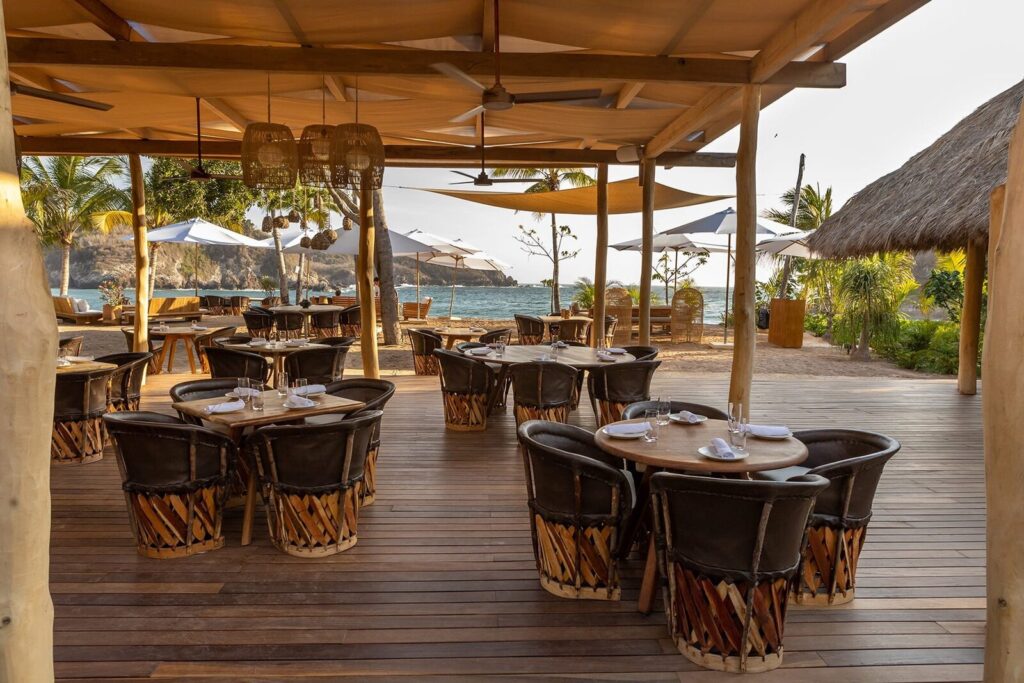 Wooden deck with tables at Lilo Beach Club, Careyes