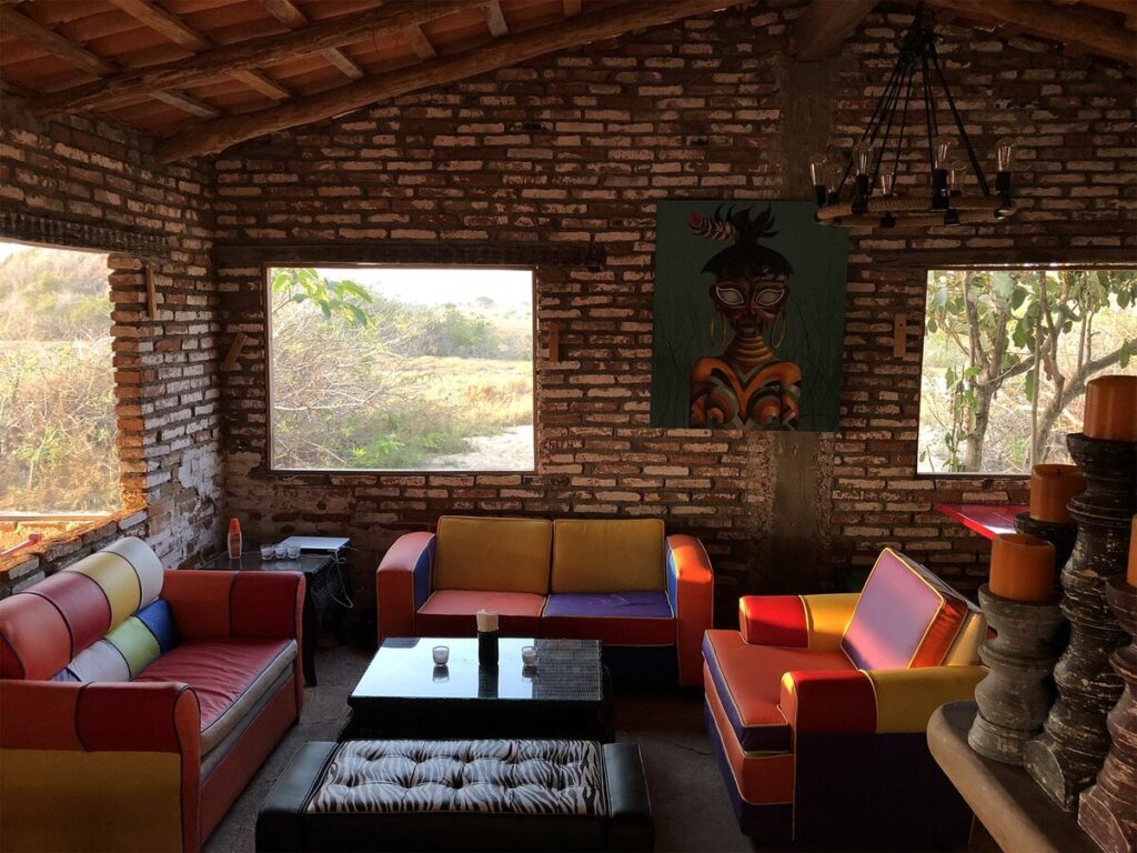Inside Casa de Nada, with brick walls and colourful sofas, Careyes