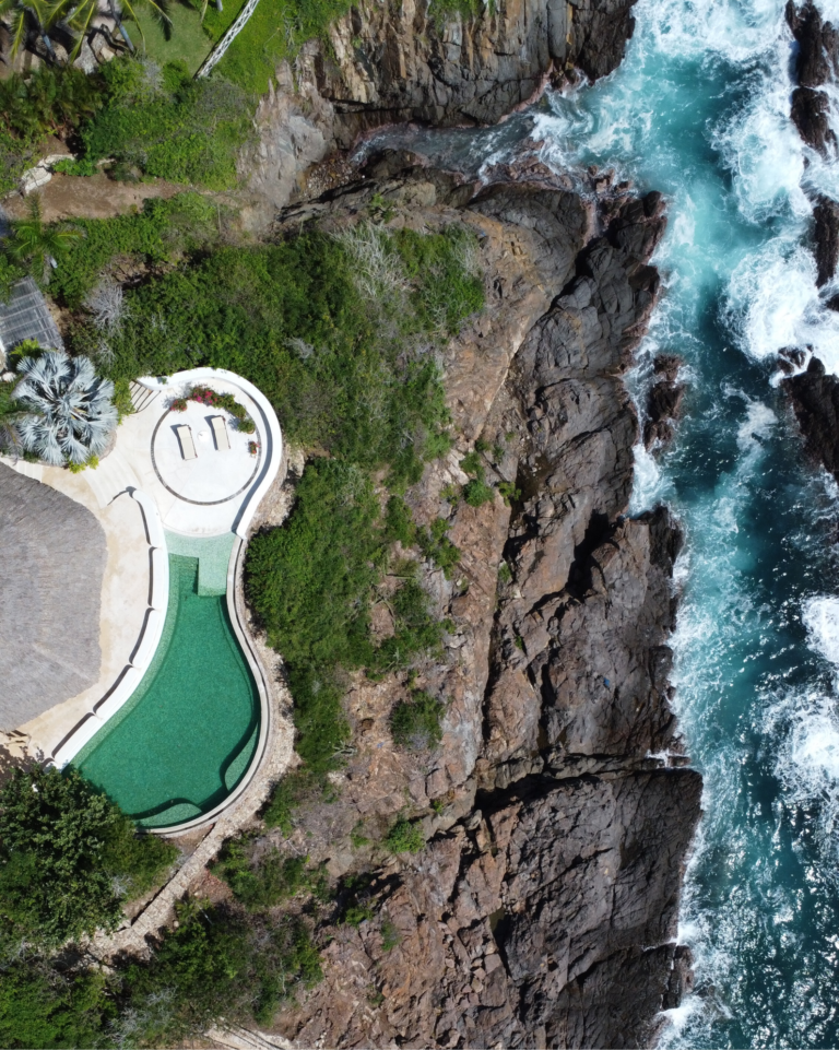 Aerial view of the cliffside infinity pool above the Pacific at Casa Papelillo