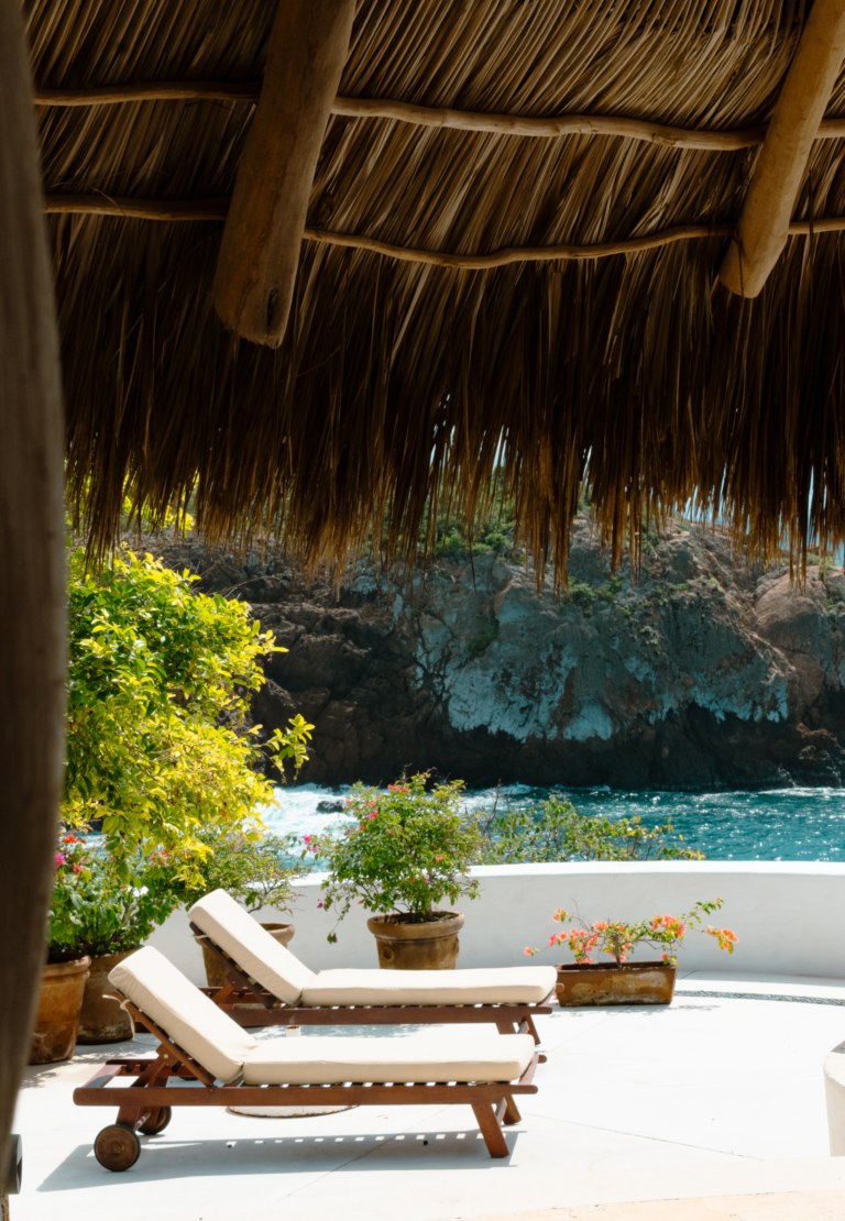 View from under the palapa roof to the rocky shoreline of Chamela Bay