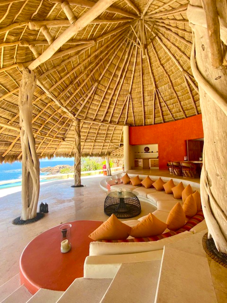Palapa living room with curved banquette seating and ocean views at Casa Papelillo