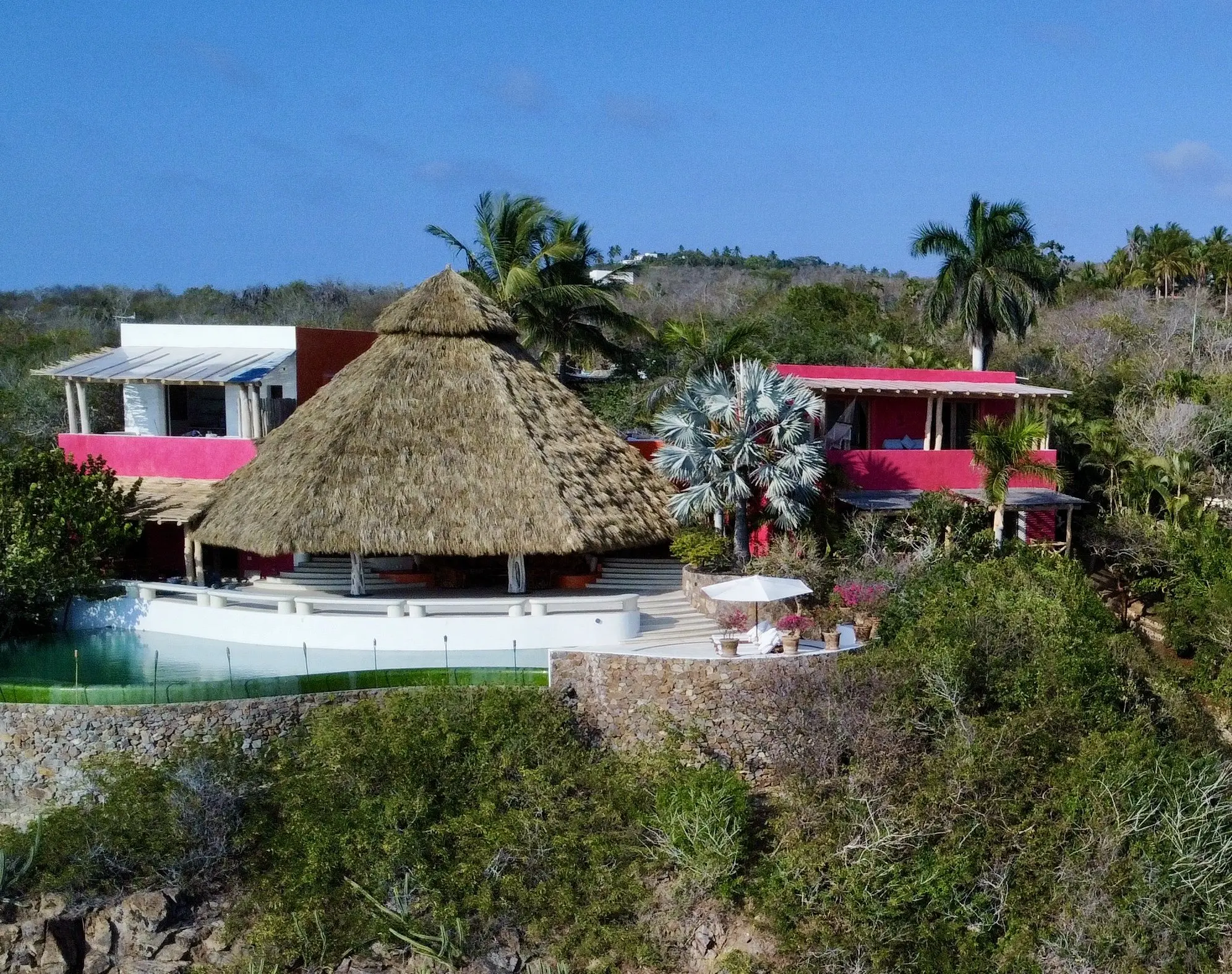 Casa Papelillo villa with its palapa, infinity pool and suites above Chamela Bay